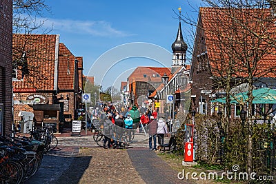 Crowded pedestrian zone in Hooksiel, Germany on a sunny spring day Editorial Stock Photo
